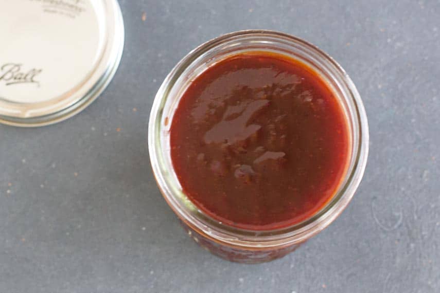 overhead image of low FODMAP Sweet and Sticky BBQ sauce in glass jar_