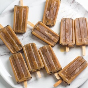 overhead image of low FODMAP cold brew oat latte popsicles laying on a round platter