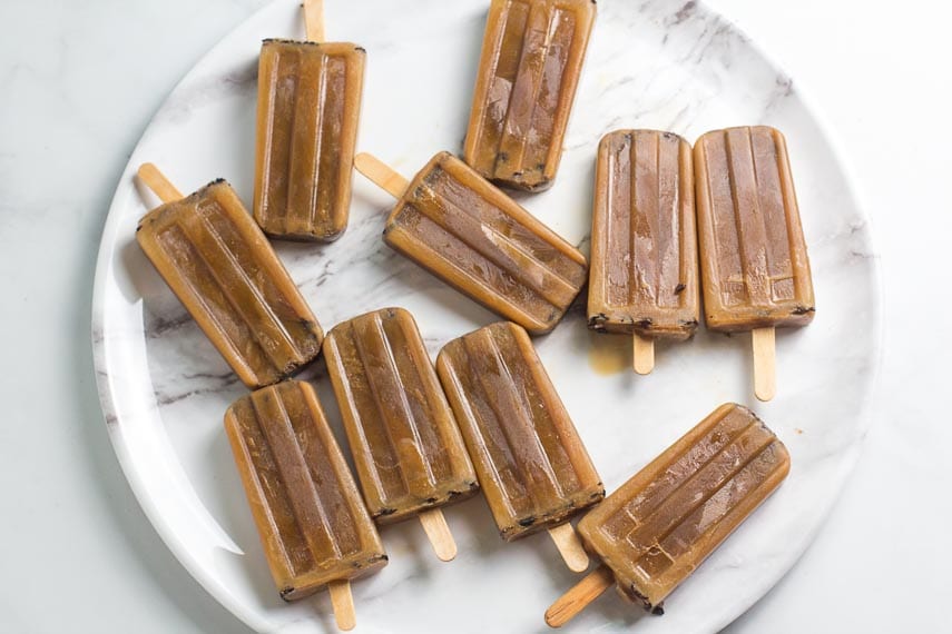 overhead image of low FODMAP cold brew oat latte popsicles laying on a round platter