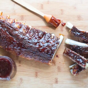 overhead view of Low FODMAP Pineapple Whiskey BBQ Ribs on wooden board
