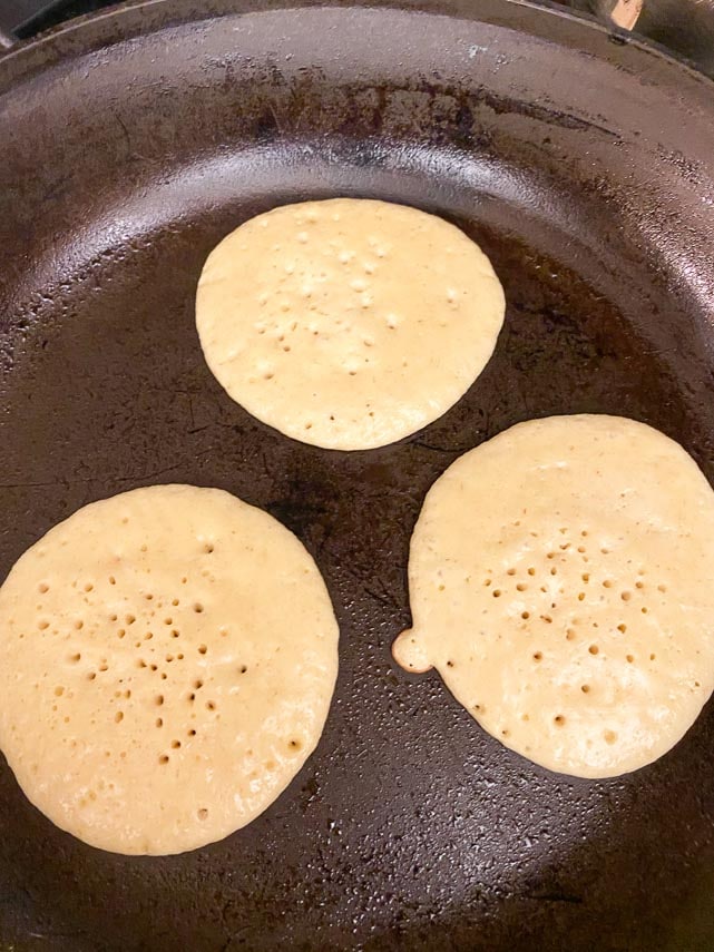 pancakes ready to flip showing bubbles that have popped