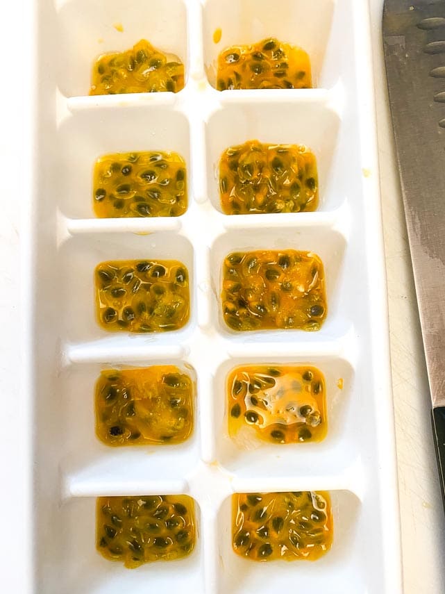 passionfruit flesh and seeds spooned into ice cube tray