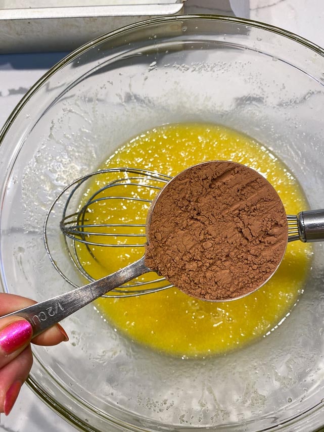 add natural cocoa to butter sugar egg mixture in glass bowl