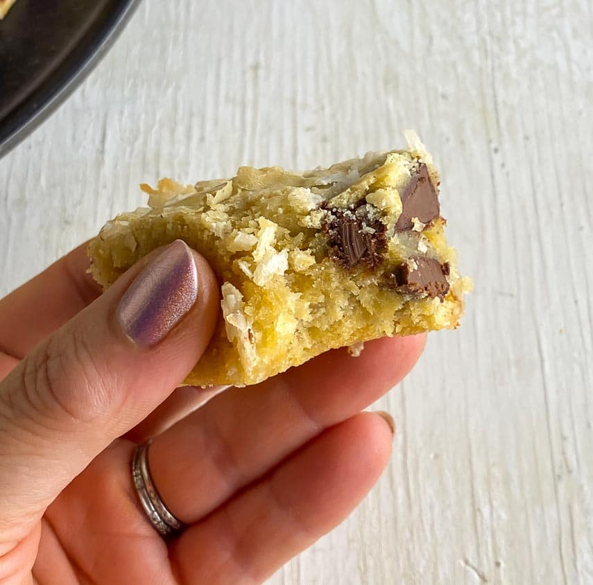 bite taken out of cookie dough blondie held in hand