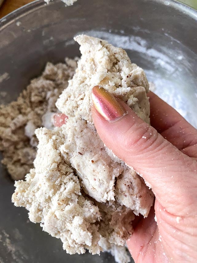 checking texture of dough; it should hold together as shown, squeezing between fingers