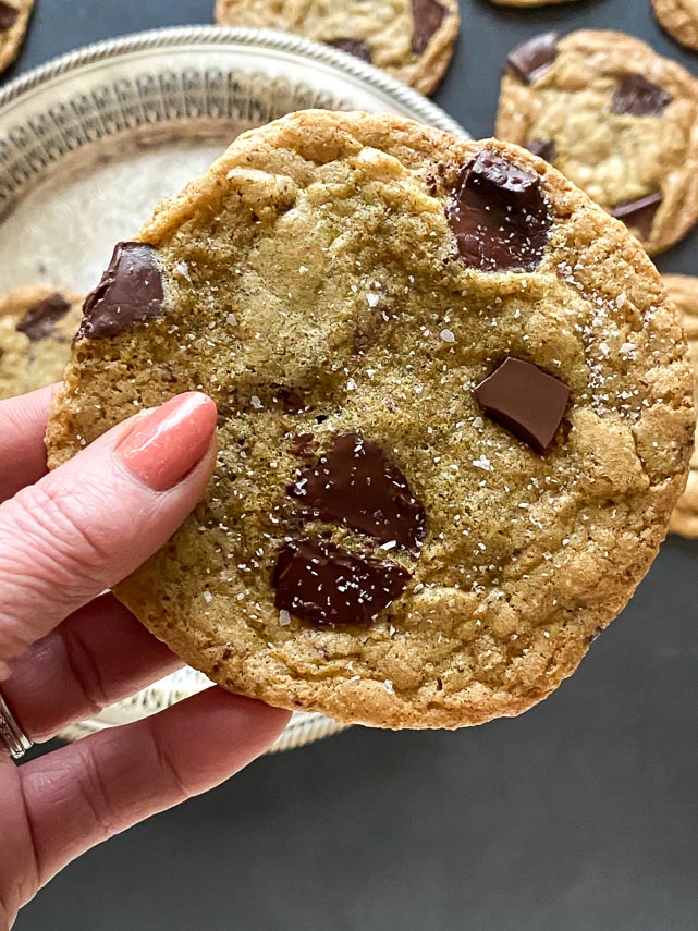 giant chocolate chunk cookie held in hand
