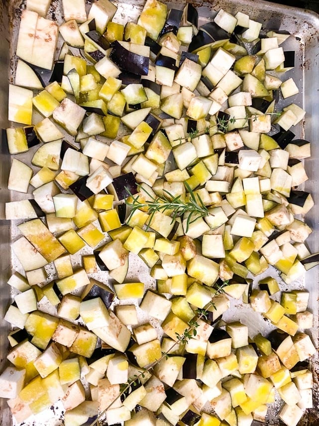 sheet pan holding eggplant cubes, drizzled with olive oil