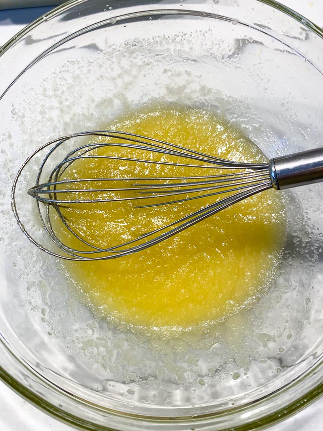 sugar and vanilla whisked into melted butter in glass bowl