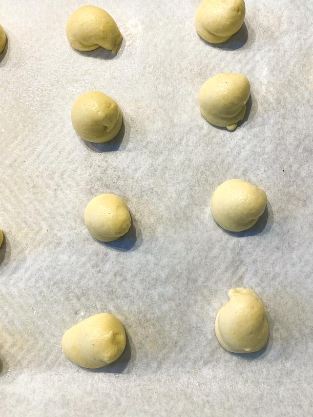 balls of pate a choux on parchment lined pan