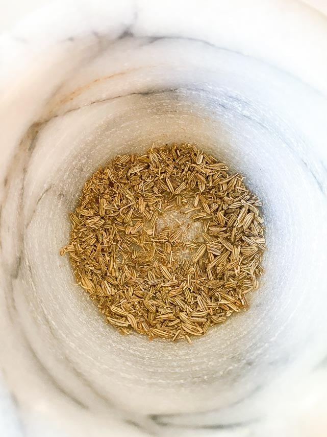 fennel seeds ground in mortar and pestle