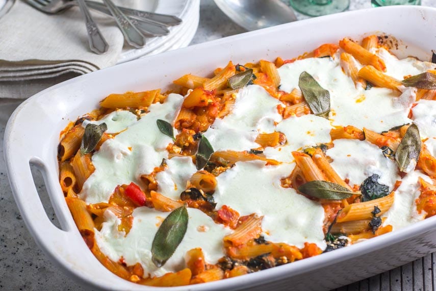 roasted pumpkin baked pasta with fresh sage in white dish