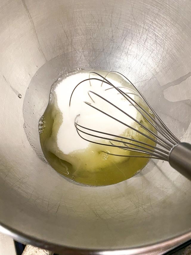 sugar and egg whites in bowl being whisked for making Swiss Meringue Buttercream