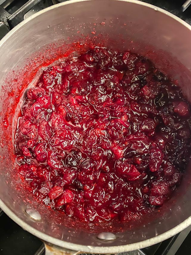 thickened cranberry filling in pot for buche de Noel