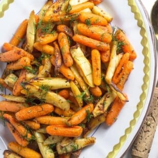 Low-FODMAP-Carrots-Parsnips-with-Dijon-butter-on-oval-platter-with-serving-spoon-and-fork