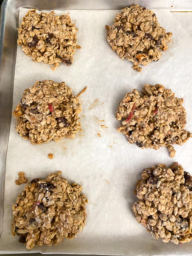 Apple oat breakfast cookies on parchment lined pan after being baked