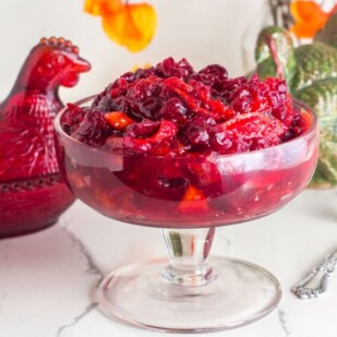 closeup up horizontal shot of cranberry sauce in footed glass dish