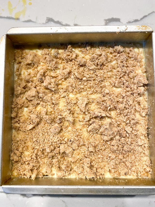raw batter and streusel on square cake ready to be baked