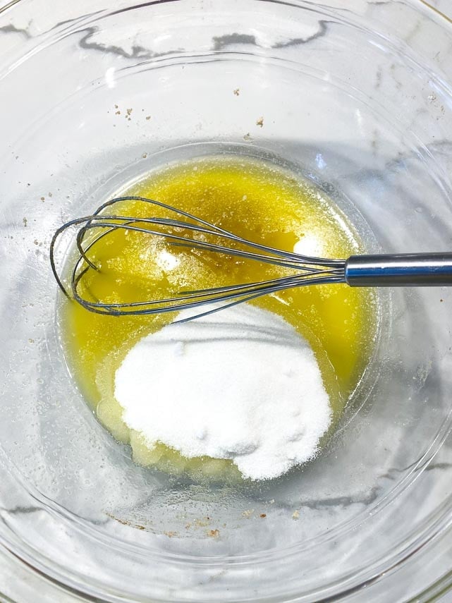 whisking butter, sugar and vanilla together in glass bowl