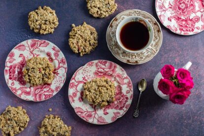 overhead-of-Low-FODMAP-Cinnamon-Apple-Breakfast-Cookies-on-pink-and-white-plates-cup-of-coffee-and-roses-in-background