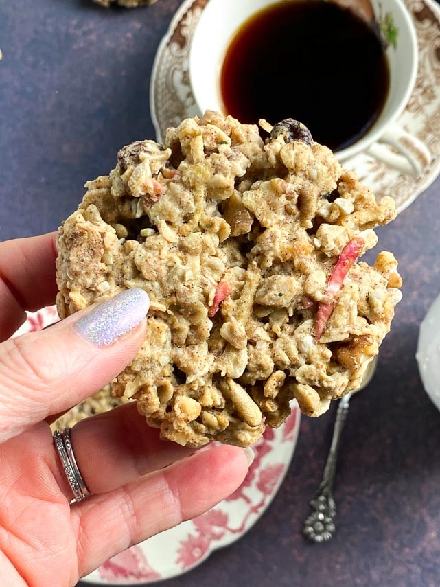 vertical-close-up-of-apple-oatmeal-breakfast-cookies-held-in-hand