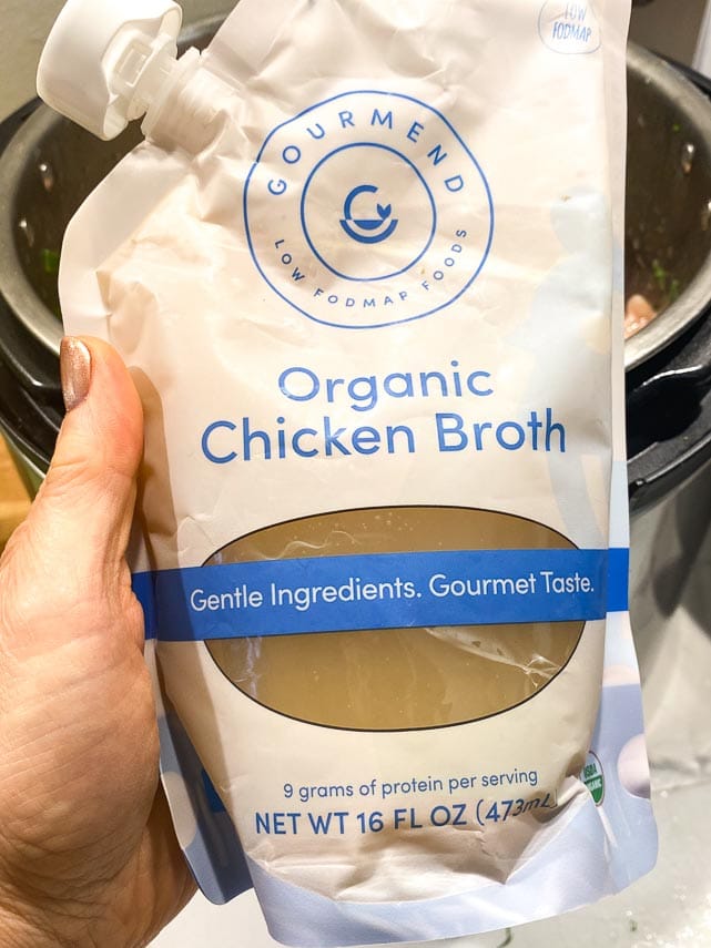 Package-of-Gourmend-Chicken-Broth-held-in-hand