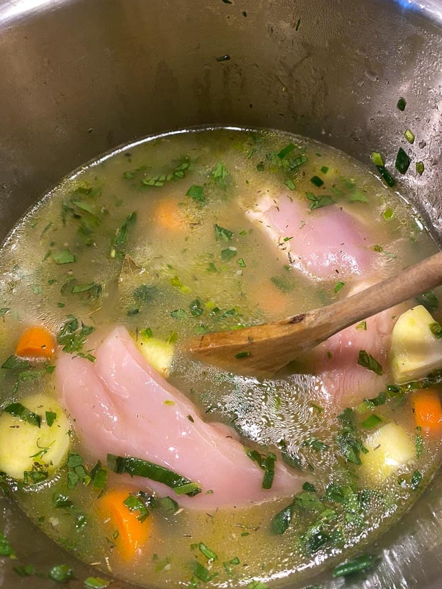 adding-chicken-and-broth-to-vegetables-in-Instant-Pot-while-making-soup