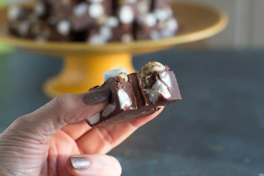 bite-taken-out-of-rocky-road-fudge-held-in-hand