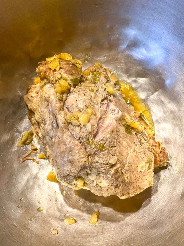cooked-Carribbean-pork-removed-from-Instant-Pot-placed-in-metal-bowl