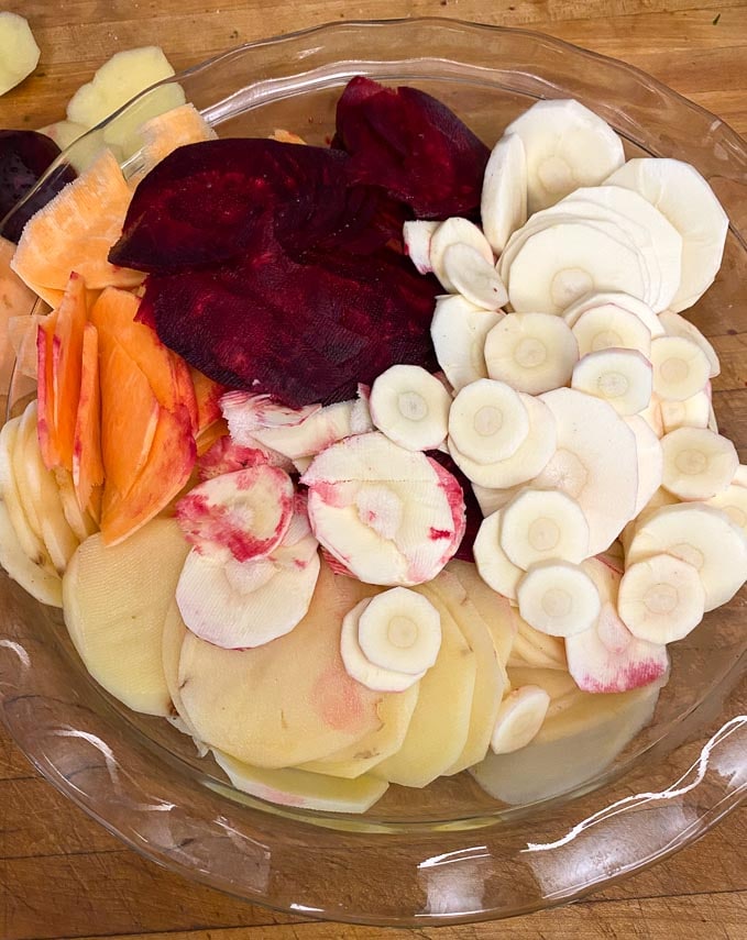 sliced-root-vegetables-in-a-glass-dish