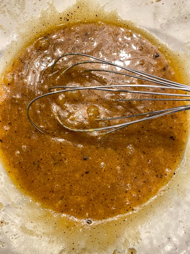 melted-butter-brown-sugar-vanilla-and-instant-coffee-in-a-glass-mixing-bowl-with-egg-whisked-in