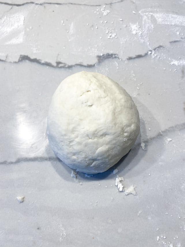 Pizza 2.0 scraped out onto floured surface, kneaded into a smooth ball