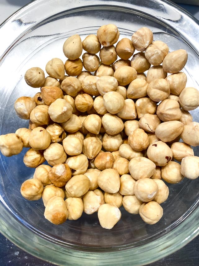 lightly toasted peeled hazelnuts in a glass bowl