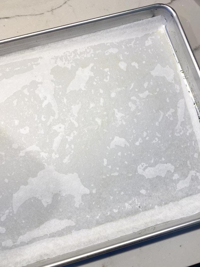 lining oiled sheet pan with parchment paper