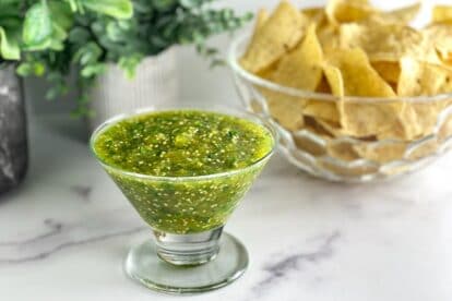 low-FODMAP-Salsa-Verde-in-glass-dish-chips-in-background
