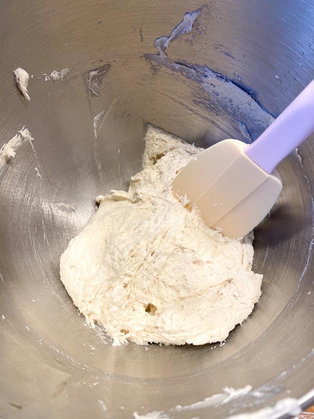 removing dough from bowl with spatula