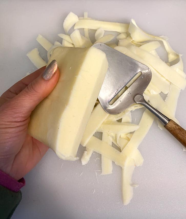 using cheese plane to make broad ribbons of cheese