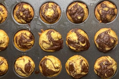 Baked mini Nutella Banana Muffins in tin, just out of oven