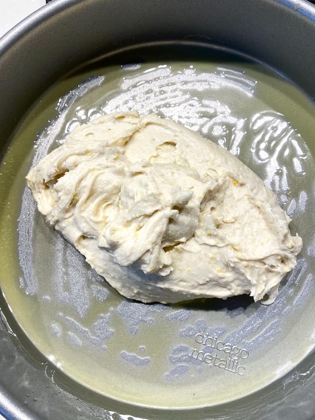 deep-dish pizza dough scraped put into butter pan