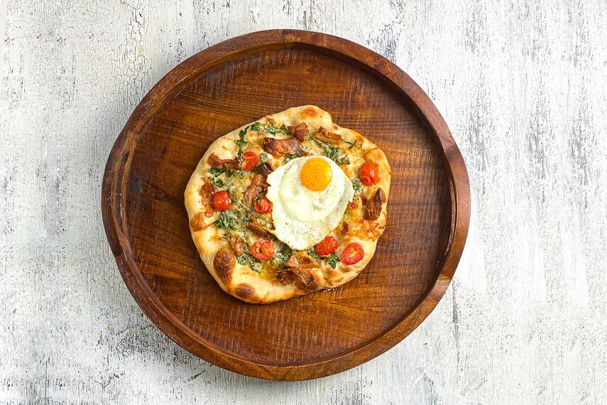 72-hour ferment pizza with egg and bacon and spinach and cherry tomatoes