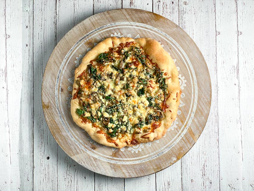 72 hour ferment pizza with spinach and feta on wooden board