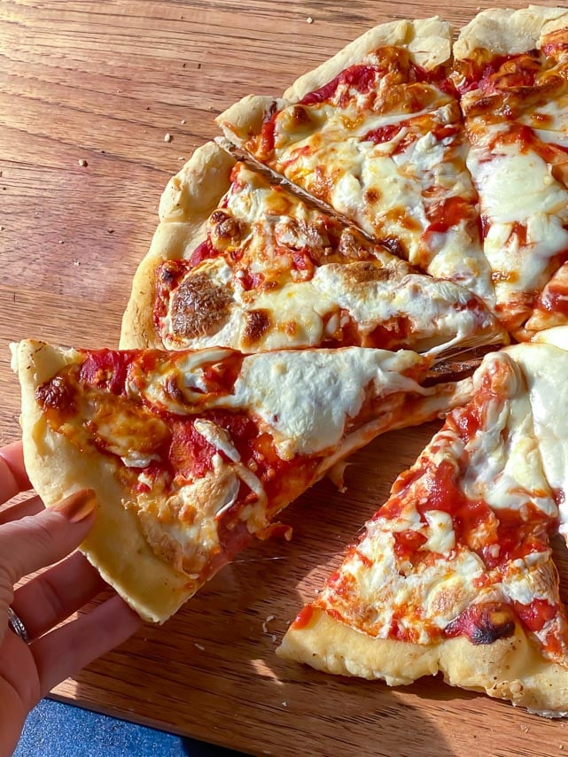 Caputo Fioreglut Gluten-Free Low FODMAP Pizza, wedge being pulled away