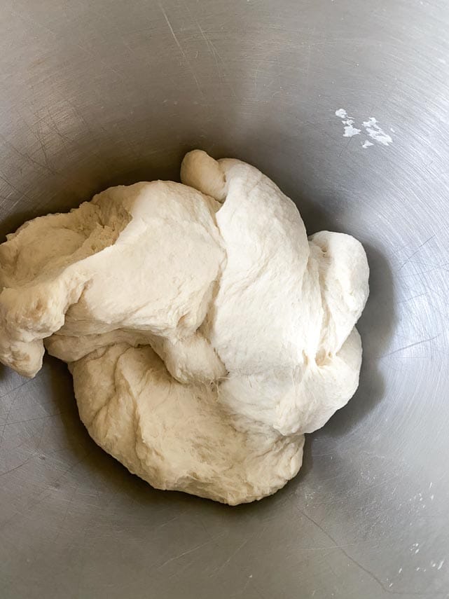 Neapolitan pizza dough finished mixing in stand mixer bowl