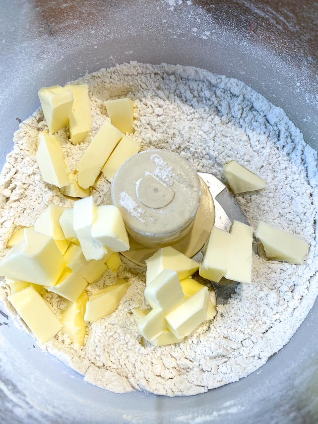 butter pieces added to cream cheese pie crust ingredients in food processor