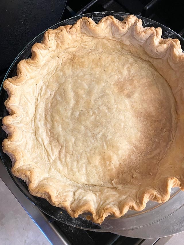 cream cheese crust blind baked in glass pie dish, fluted edges