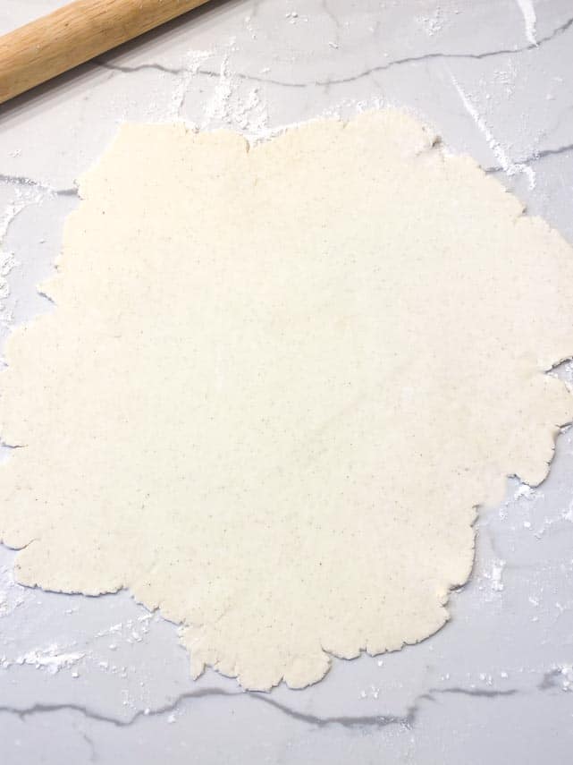 cream cheese dough rolled out on marble