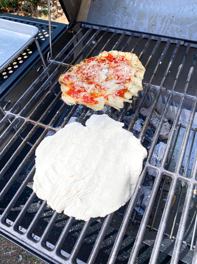 two grilled pizzas on the grill at same time