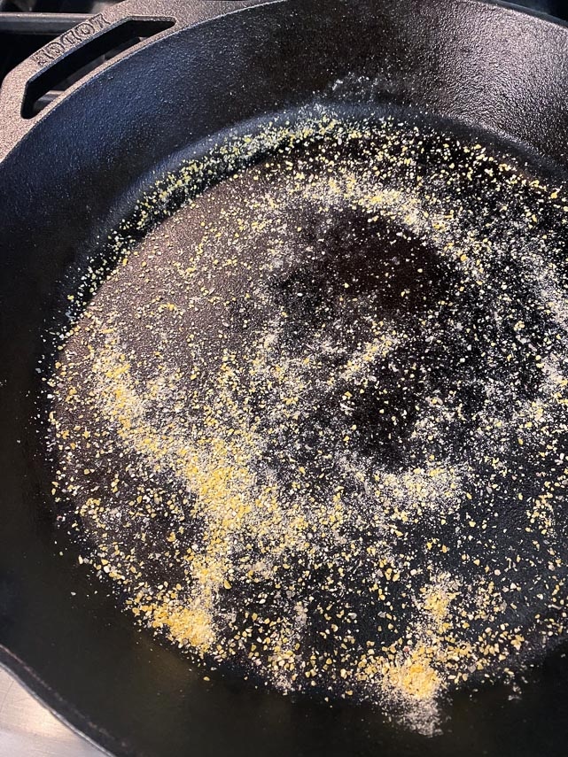 cornmeal scattered on 12-inch cast iron skillet