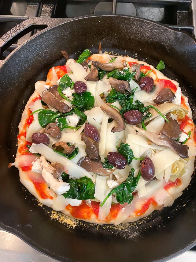 sourdough pizza covered with vegetables about to go in oven
