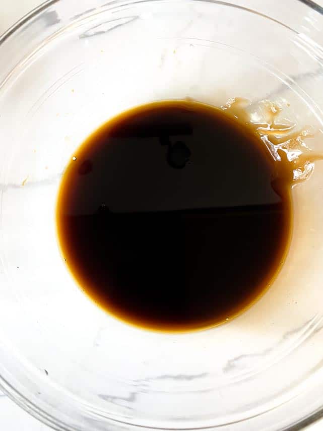 soy sauce and oyster sauce in glass bowl on white background