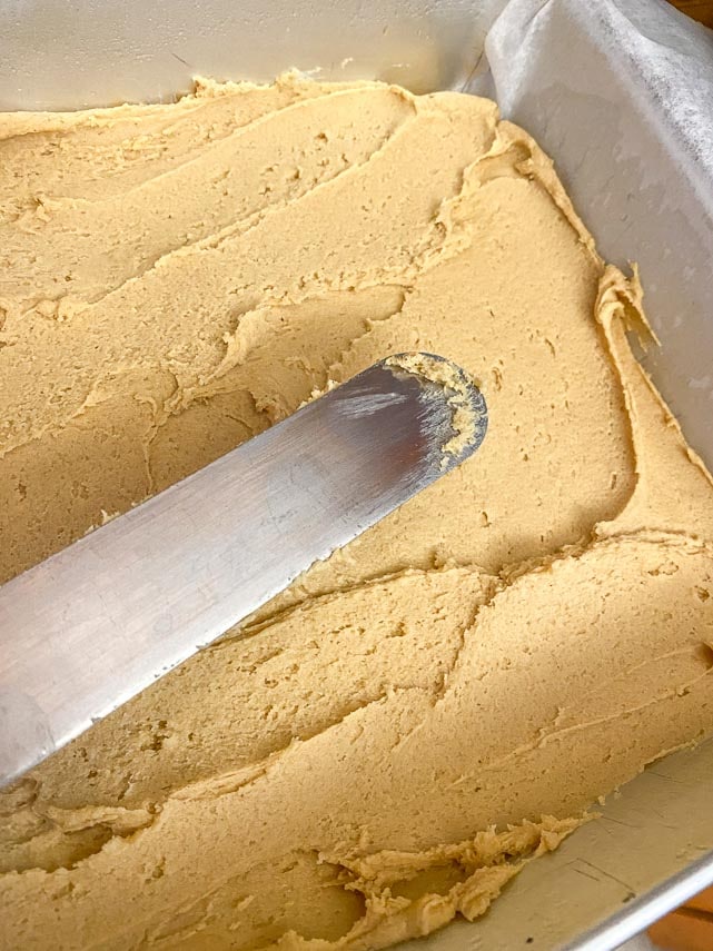 spreading peanut butter bar batter in pan